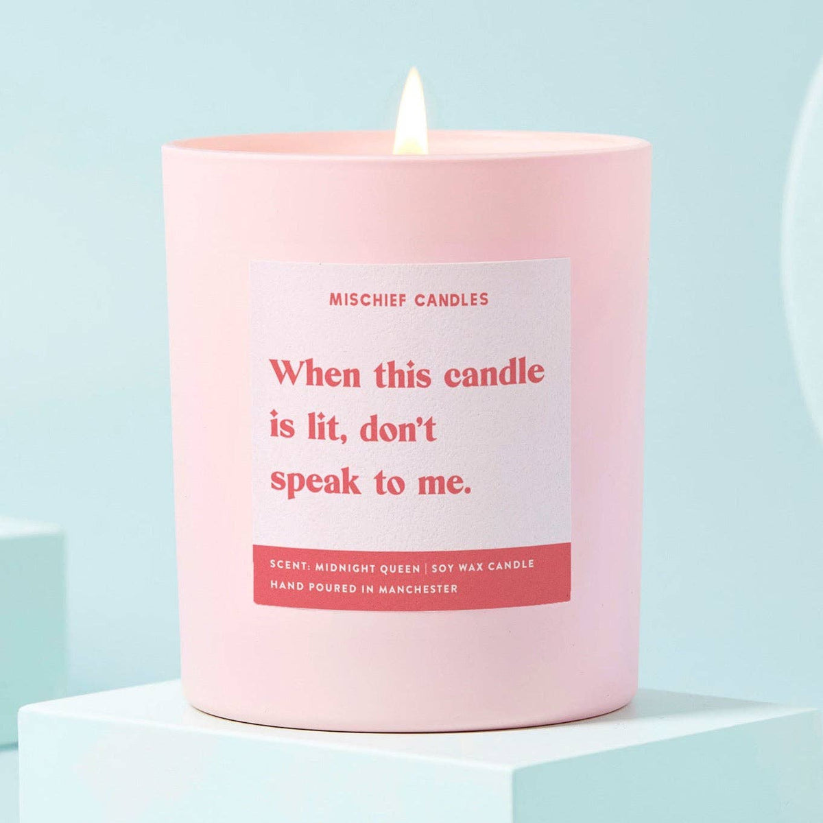 When this candle is lit, don't speak to me funny candle in a pink glass jar