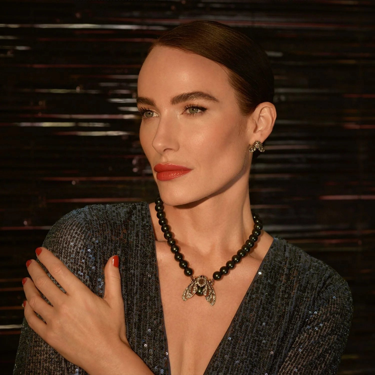 Model wearing Bill Skinner Moth Statement Necklace styled with a dark sequin dress, highlighting the crystal-studded moth pendant.