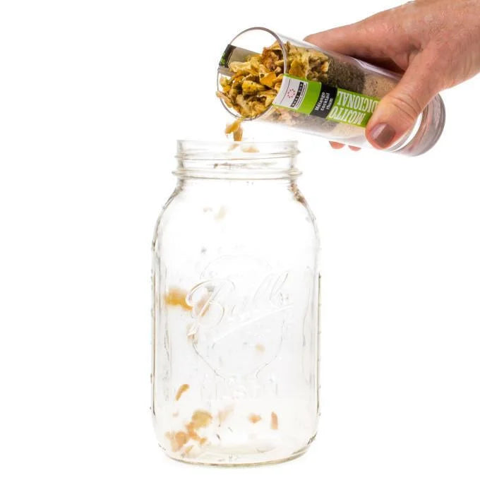 Mojito Mix being poured into a large mason jar for infusion.