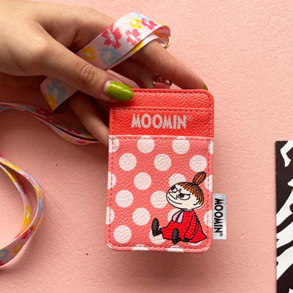Hand holding Moomin Little My Lanyard with pink polka dots and character design on pink background.
