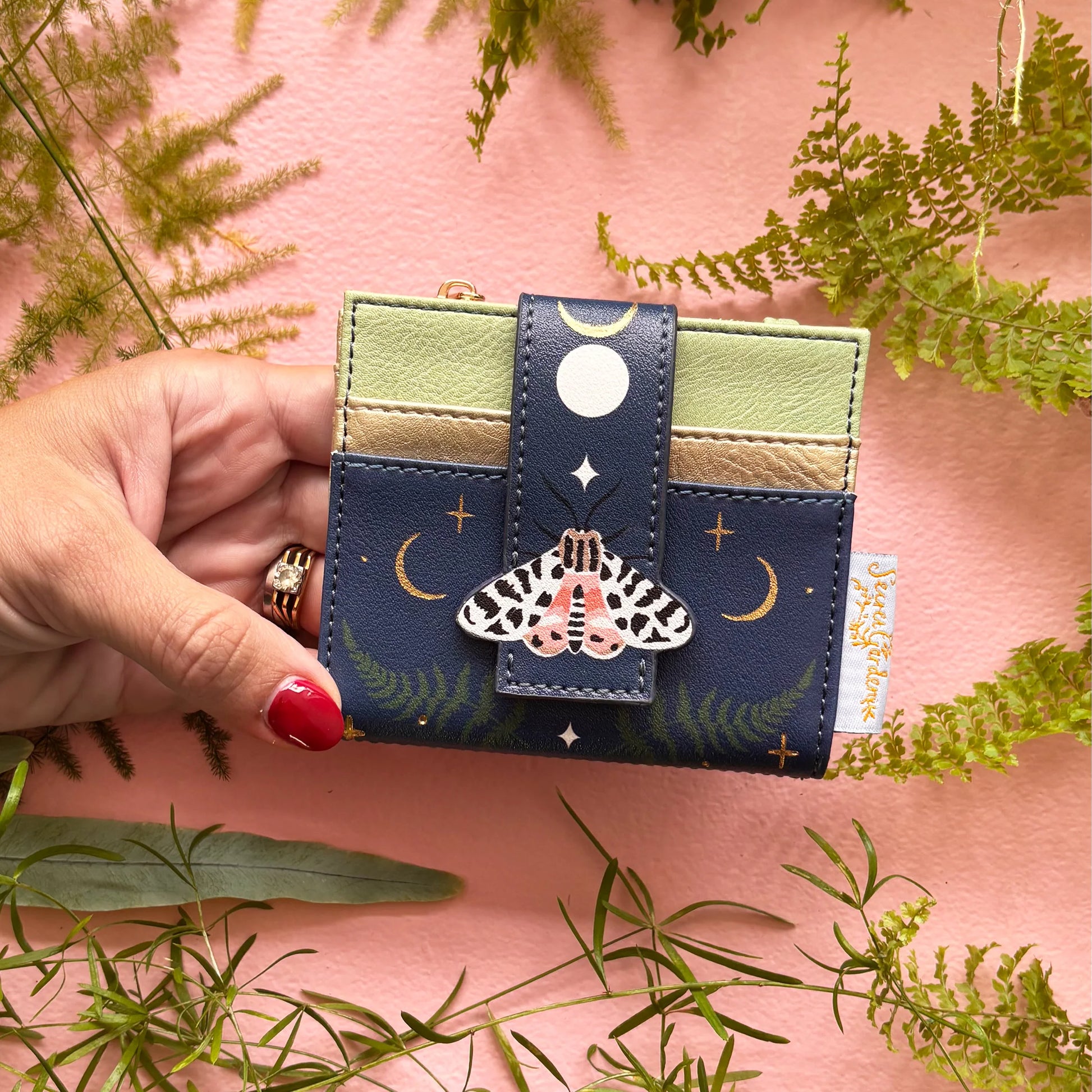 Moth purse held in hand showing compact size