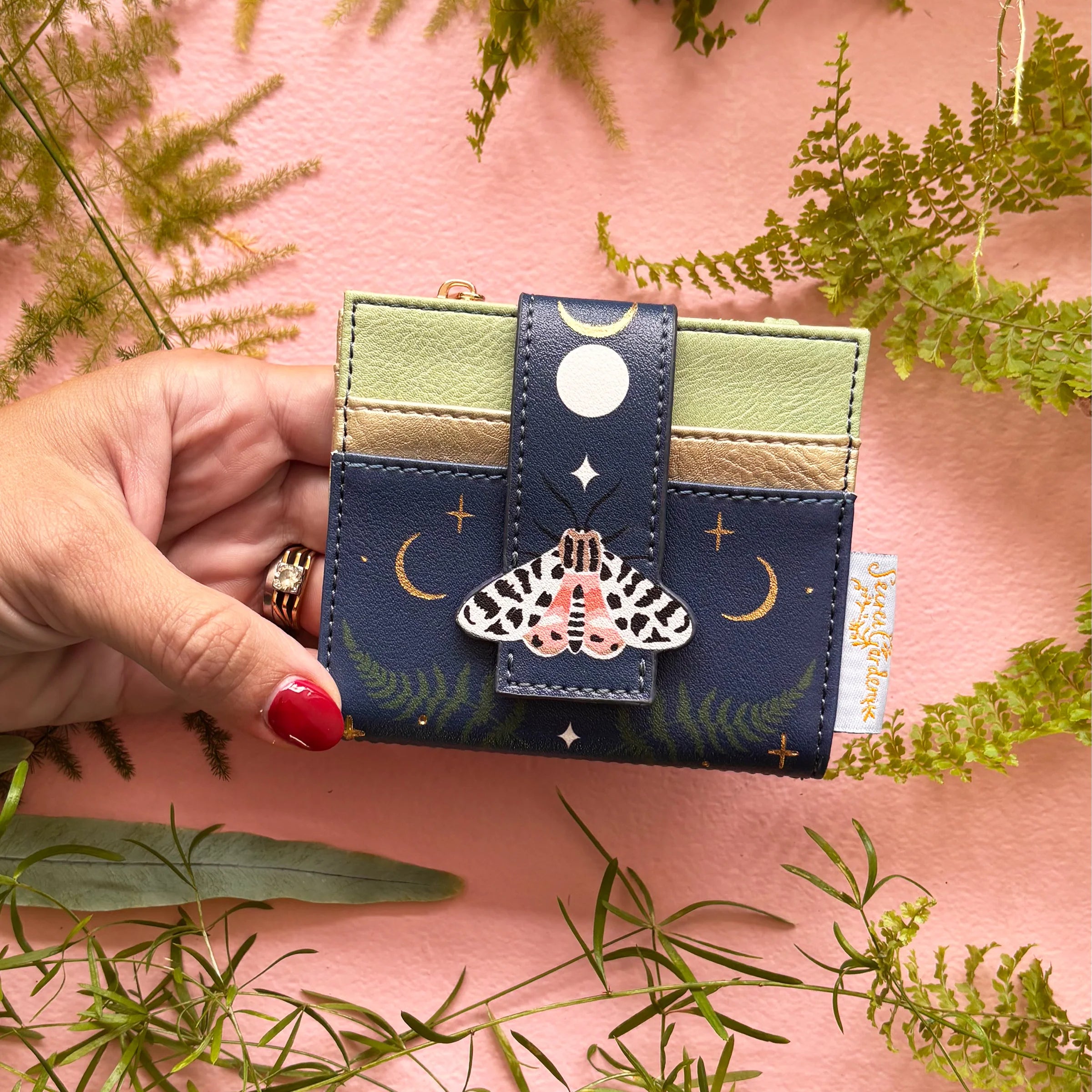 Moth purse held in hand showing compact size