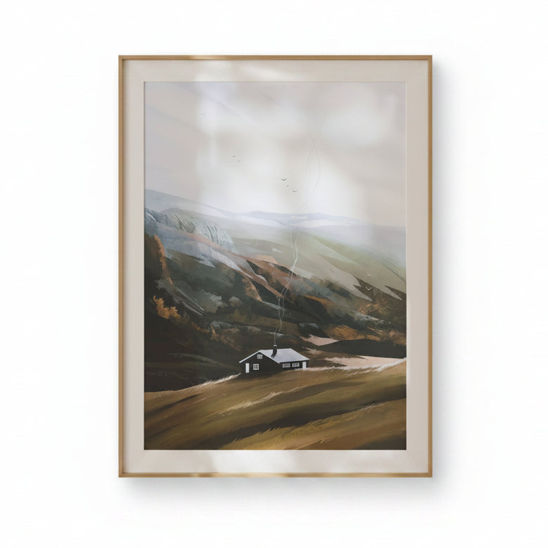 Framed landscape painting of a house on a hillside against a white wall.