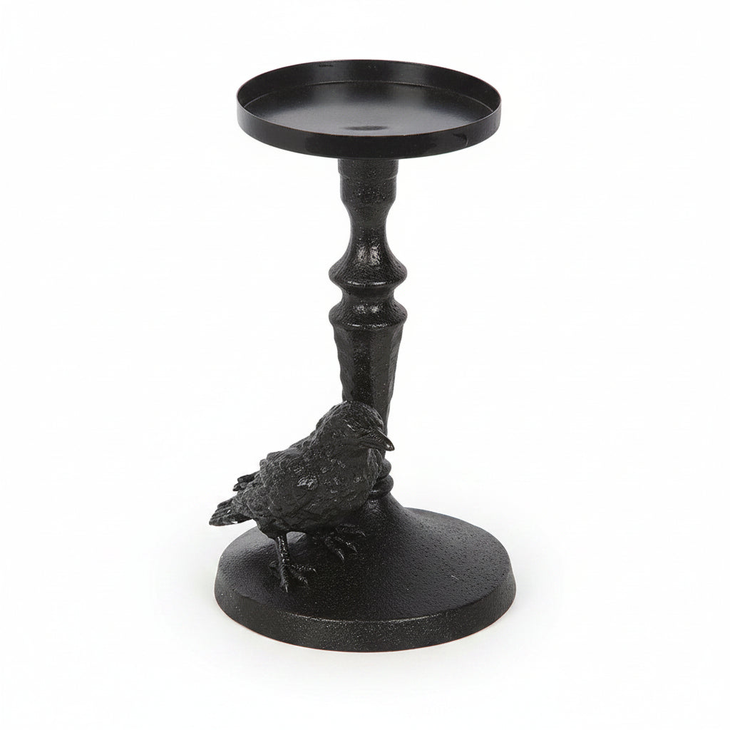 Black raven perched on gothic base candle holder