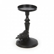 Black raven perched on gothic base candle holder