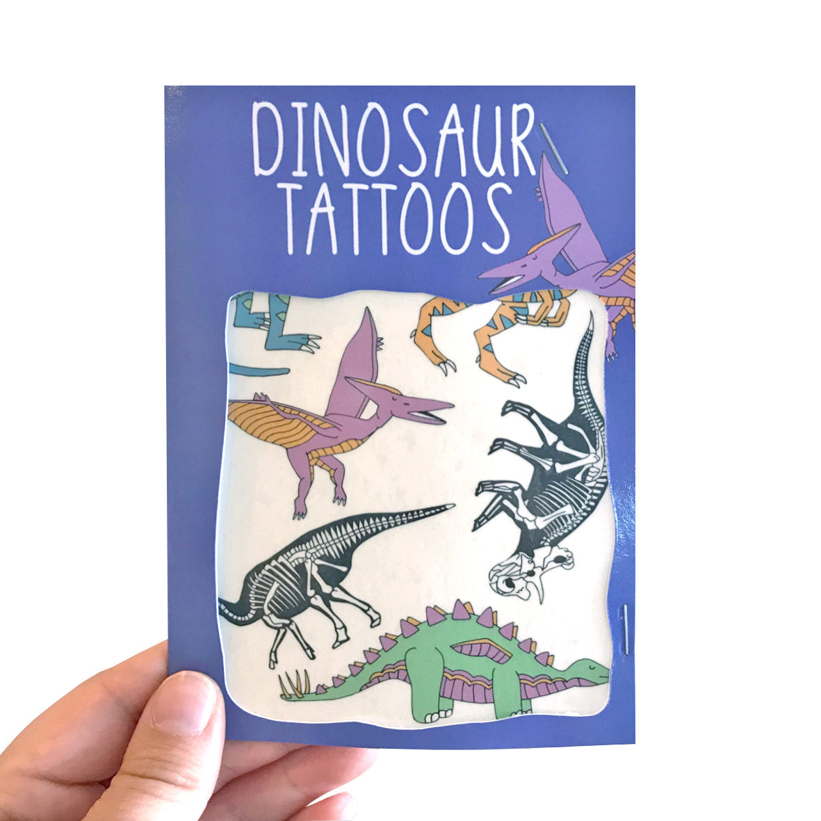 Dinosaur transfer tattoos pack held in a hand