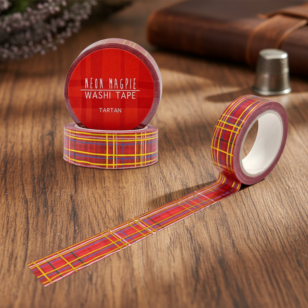 Tartan washi tape roll partly unrolled beside its packaging