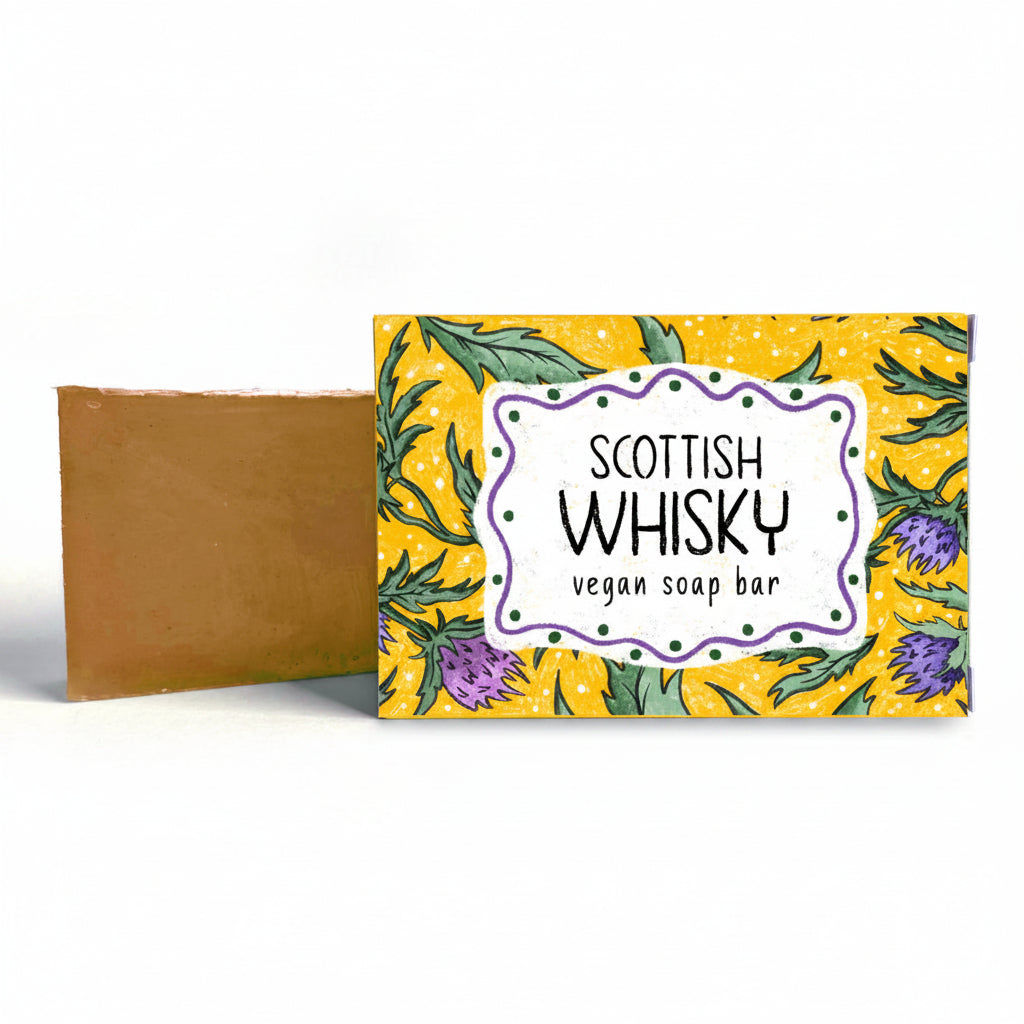 Neon Magpie Scottish Whisky vegan soap bar beside its thistle-print packaging box