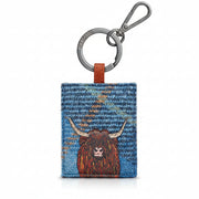 Highland cow keyring in blue tweed-effect vegan leather, front view on grey