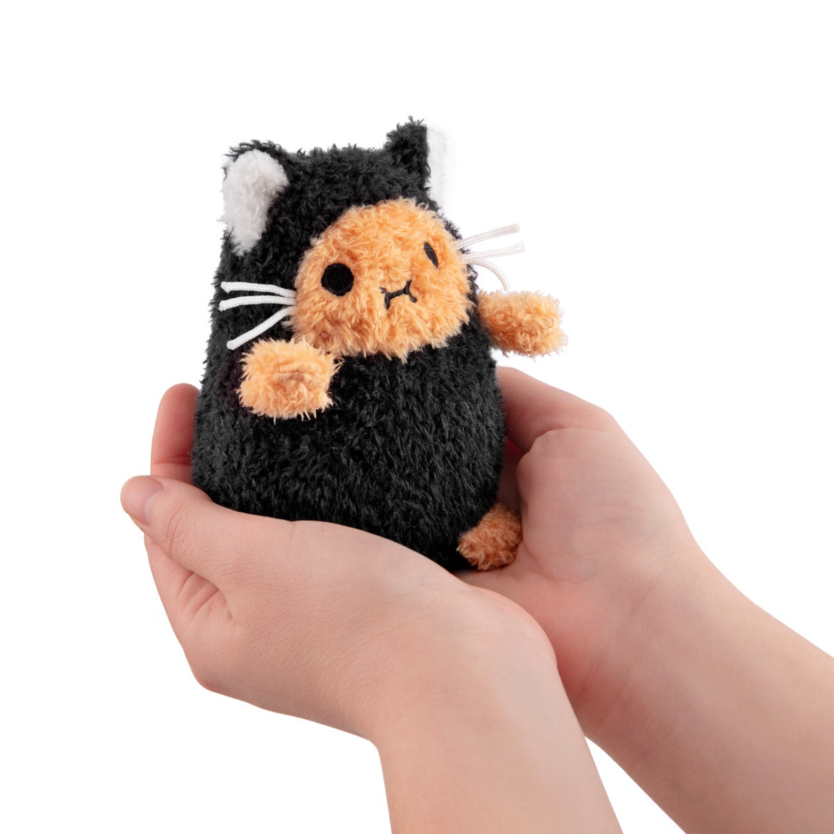 Black Kitty Ricespud mini plush held in two cupped hands to show its size