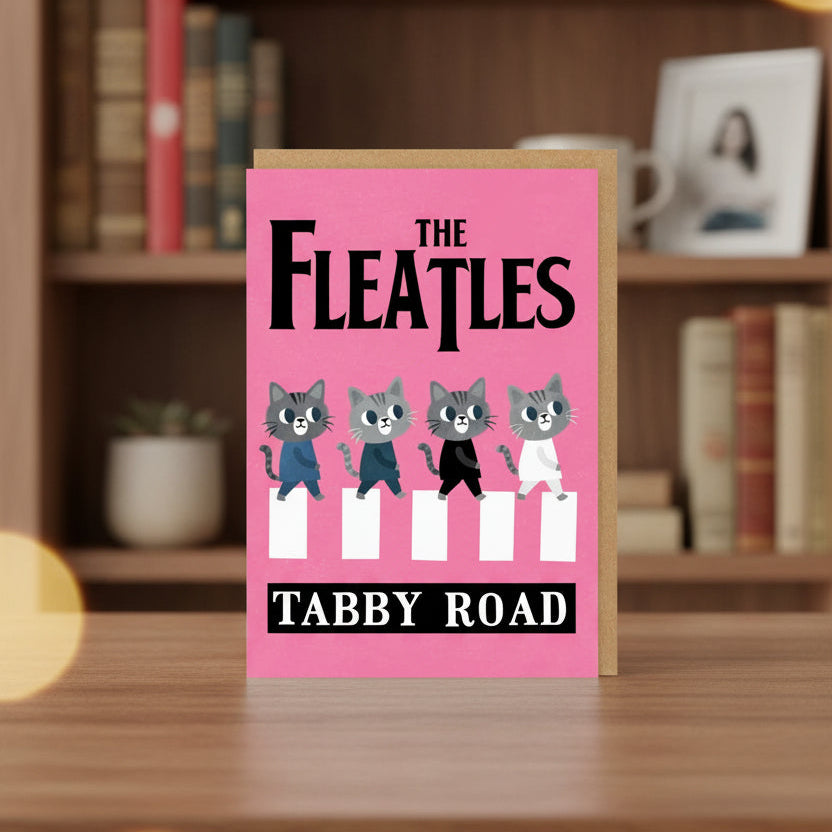 Card with cartoon cats on a pink background, styled like The Beatles Abbey Road album cover.