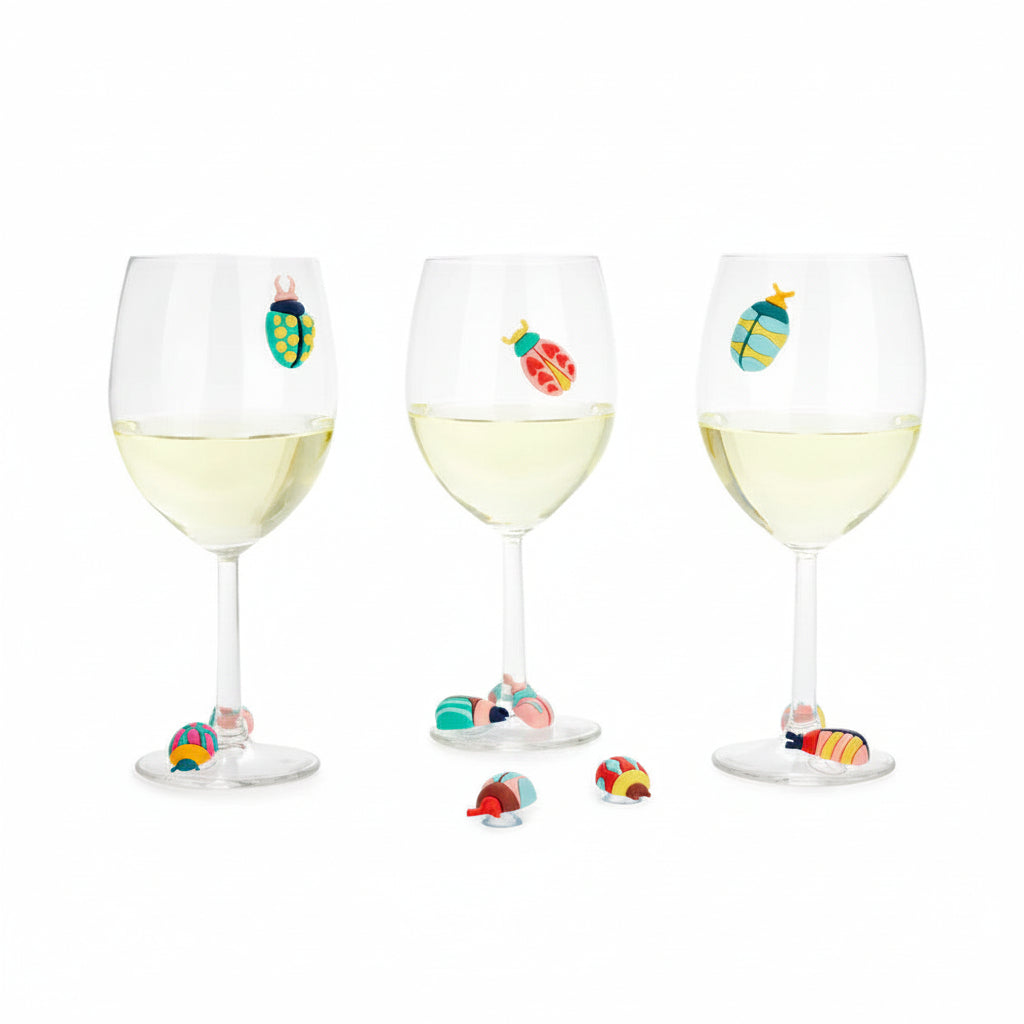 Three wine glasses with beetle markers and beetles displayed on table