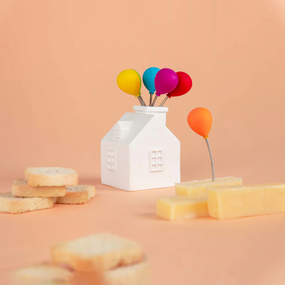 Snack forks arranged in balloon house stand with cheese and crackers