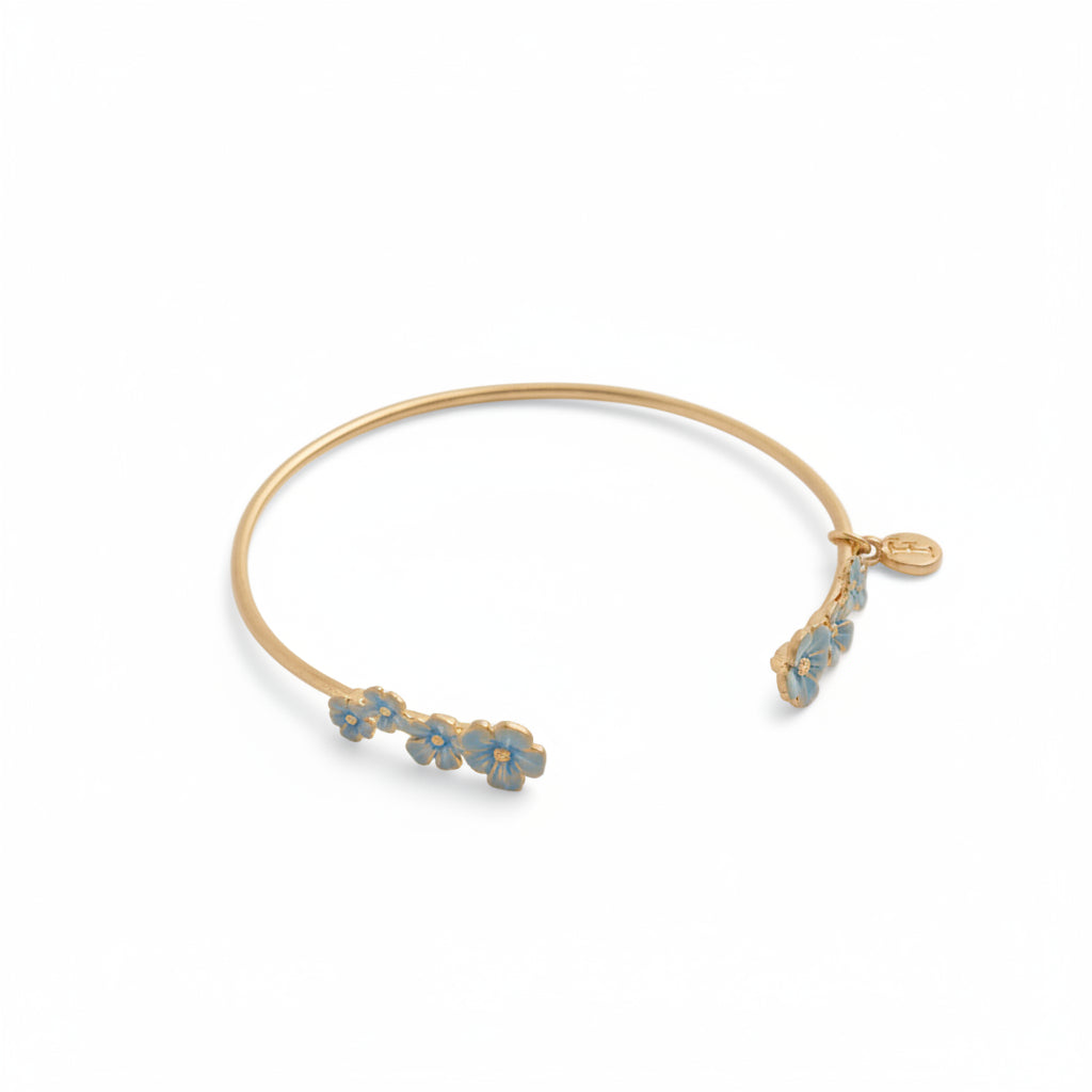 Open gold-plated forget-me-not bangle with blue enamel floral detailing