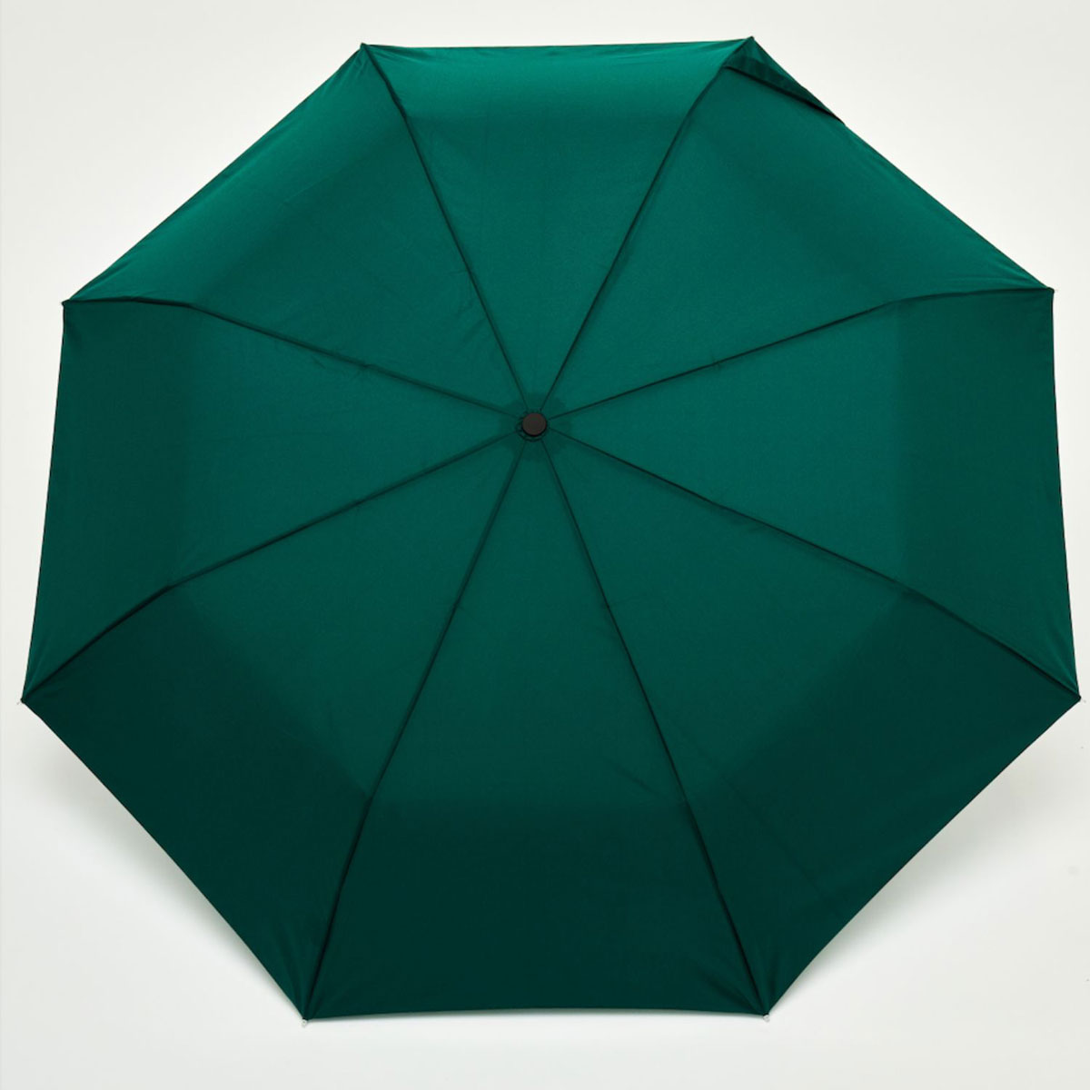 Top-down view of open forest green duck umbrella canopy