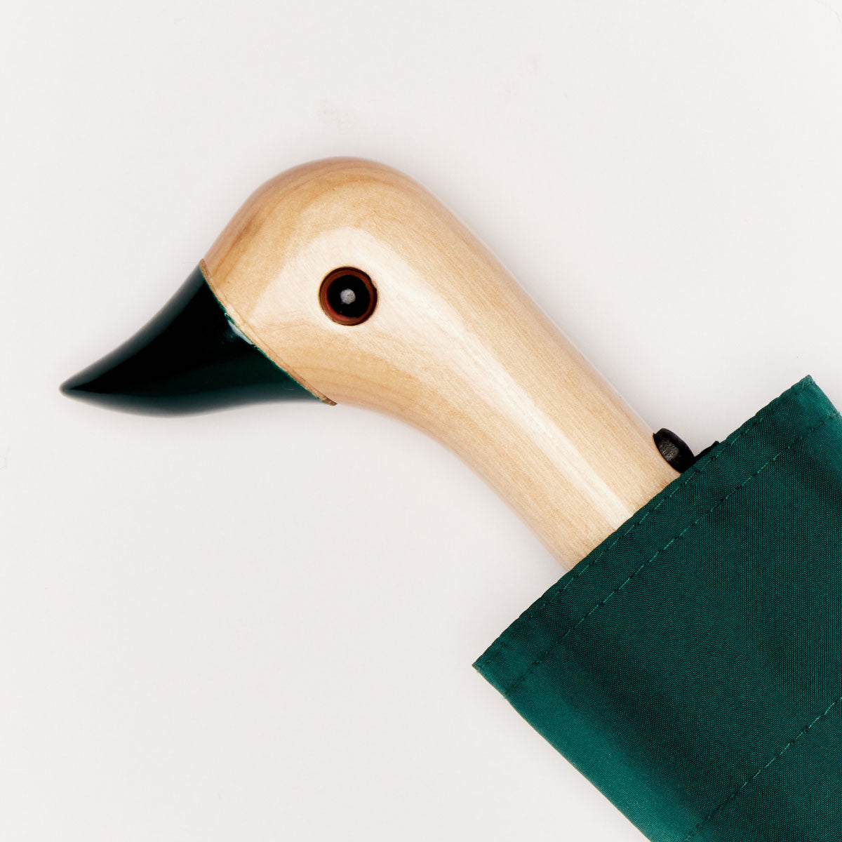 Close-up of wooden duck head handle with dark green beak on white background