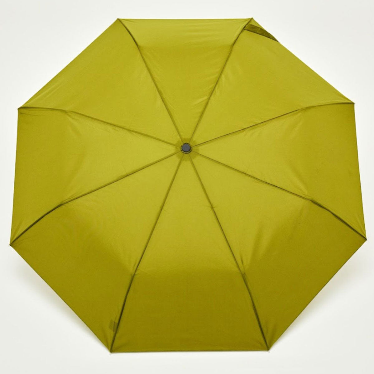 Top-down view of open olive duck umbrella canopy on beige background