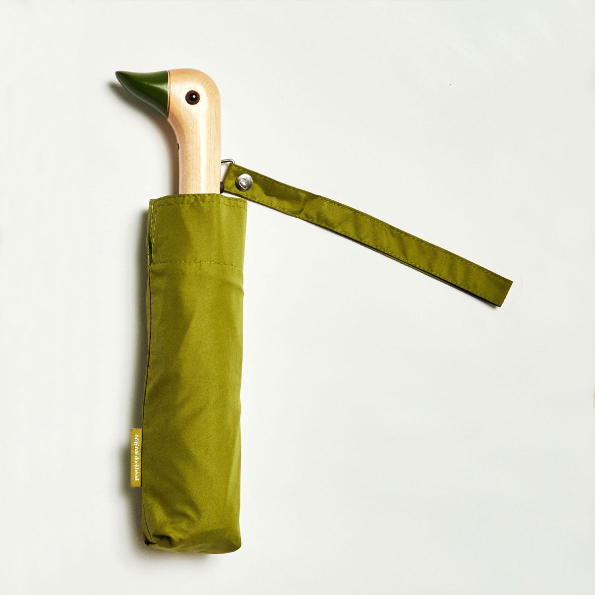 Closed olive duck umbrella flat lay showing wooden duck head handle