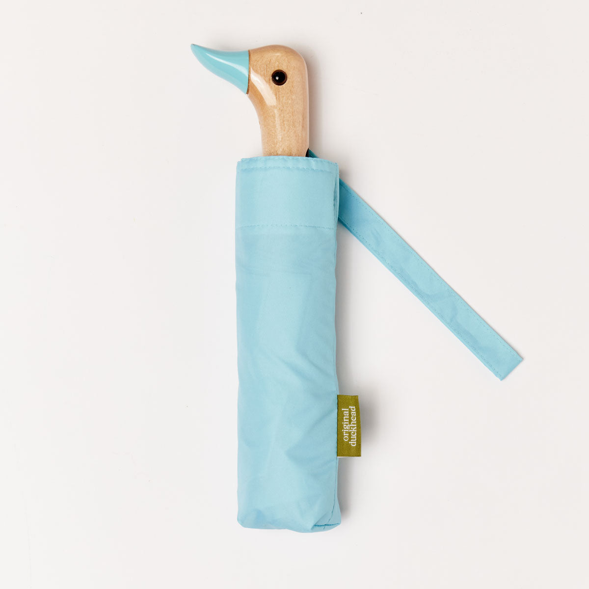 Closed sky blue duck umbrella flat lay showing wooden duck head handle