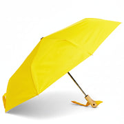 Yellow compact duck umbrella open side view on light background