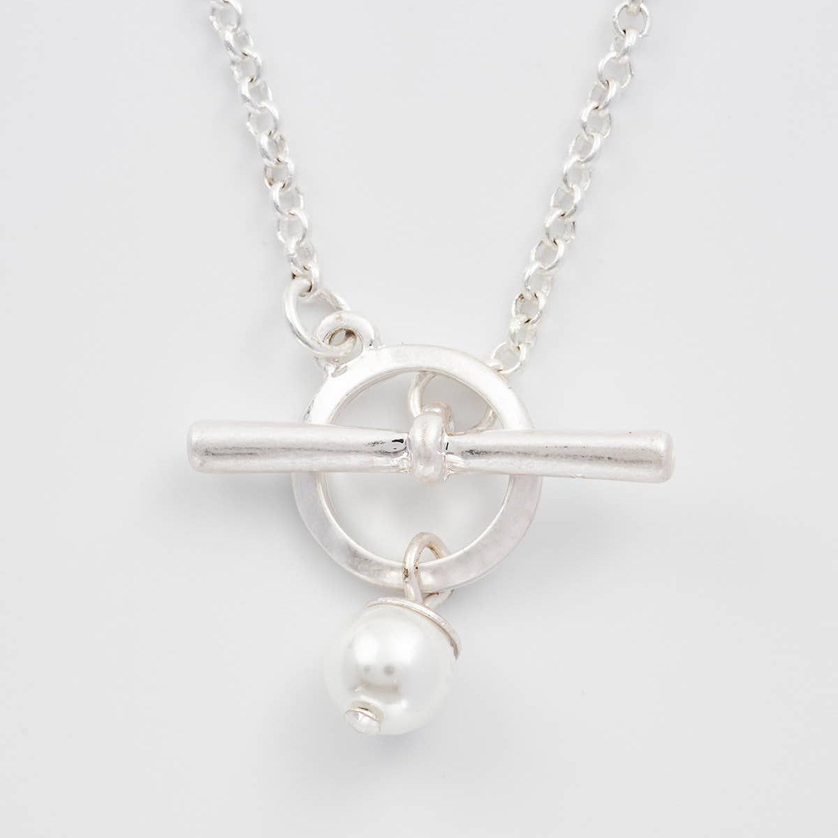 Close-up of silver toggle clasp with faux pearl charm