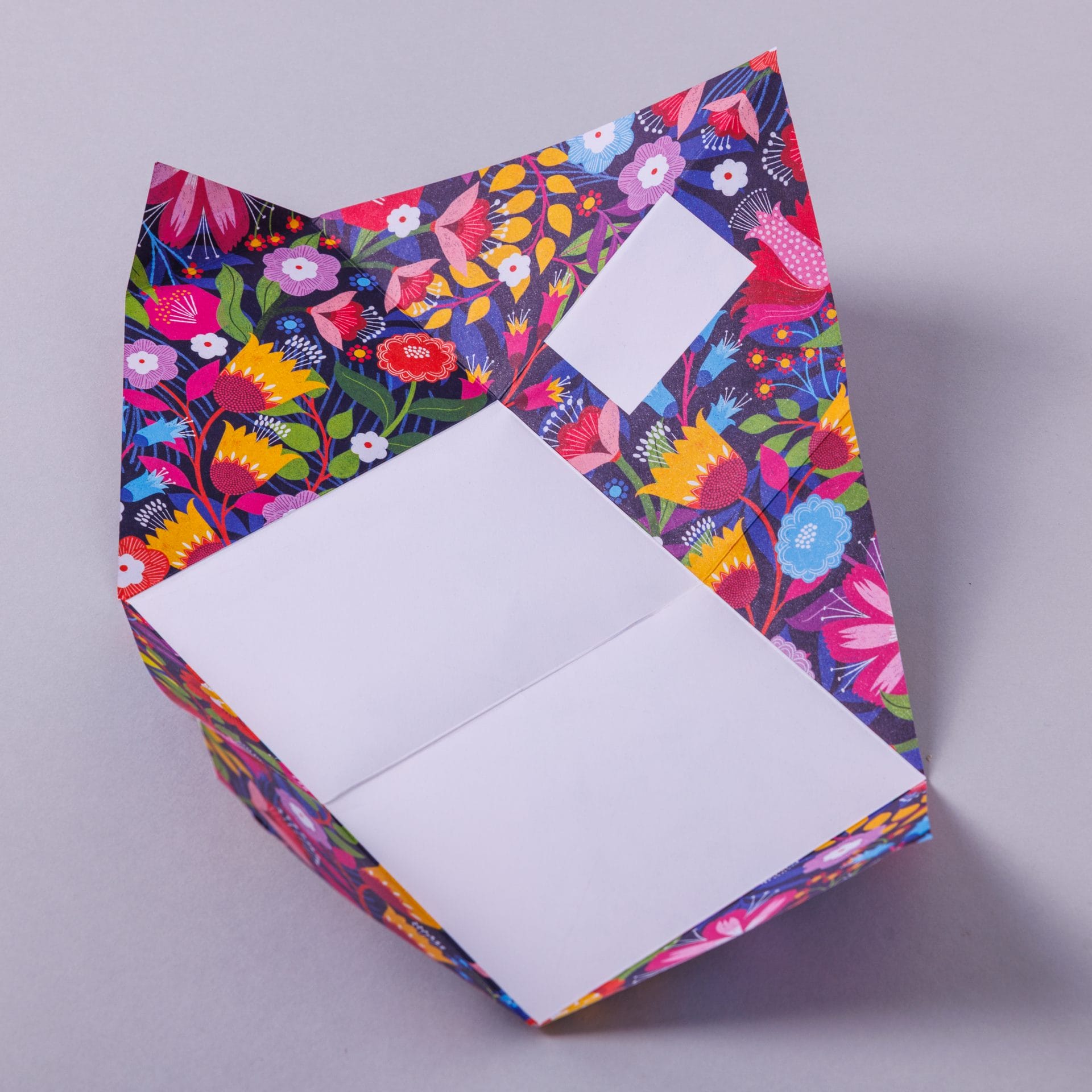Folded Pigeon letter with tropical floral design on navy first variant