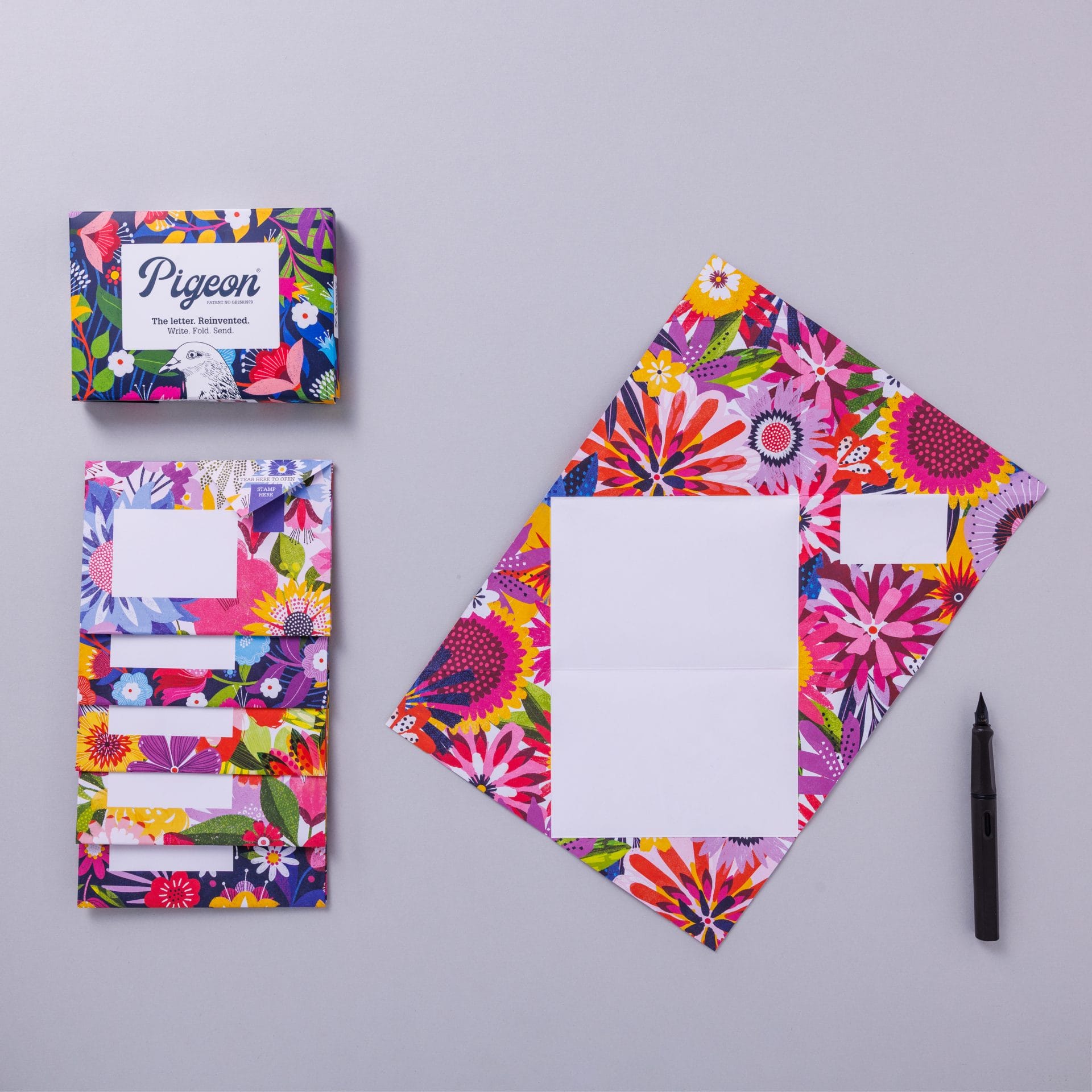 Unfolded Floral Fantasia Pigeon showing vibrant tropical floral interior on grey
