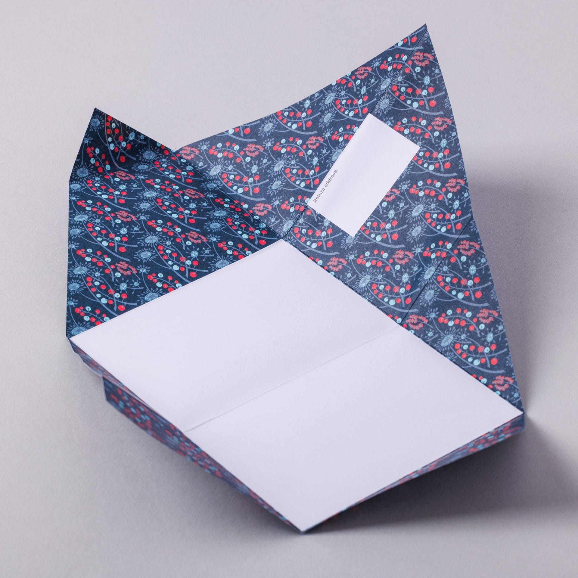 Unfolded Hedgerow Pigeon with botanical berry and flower interior on grey background