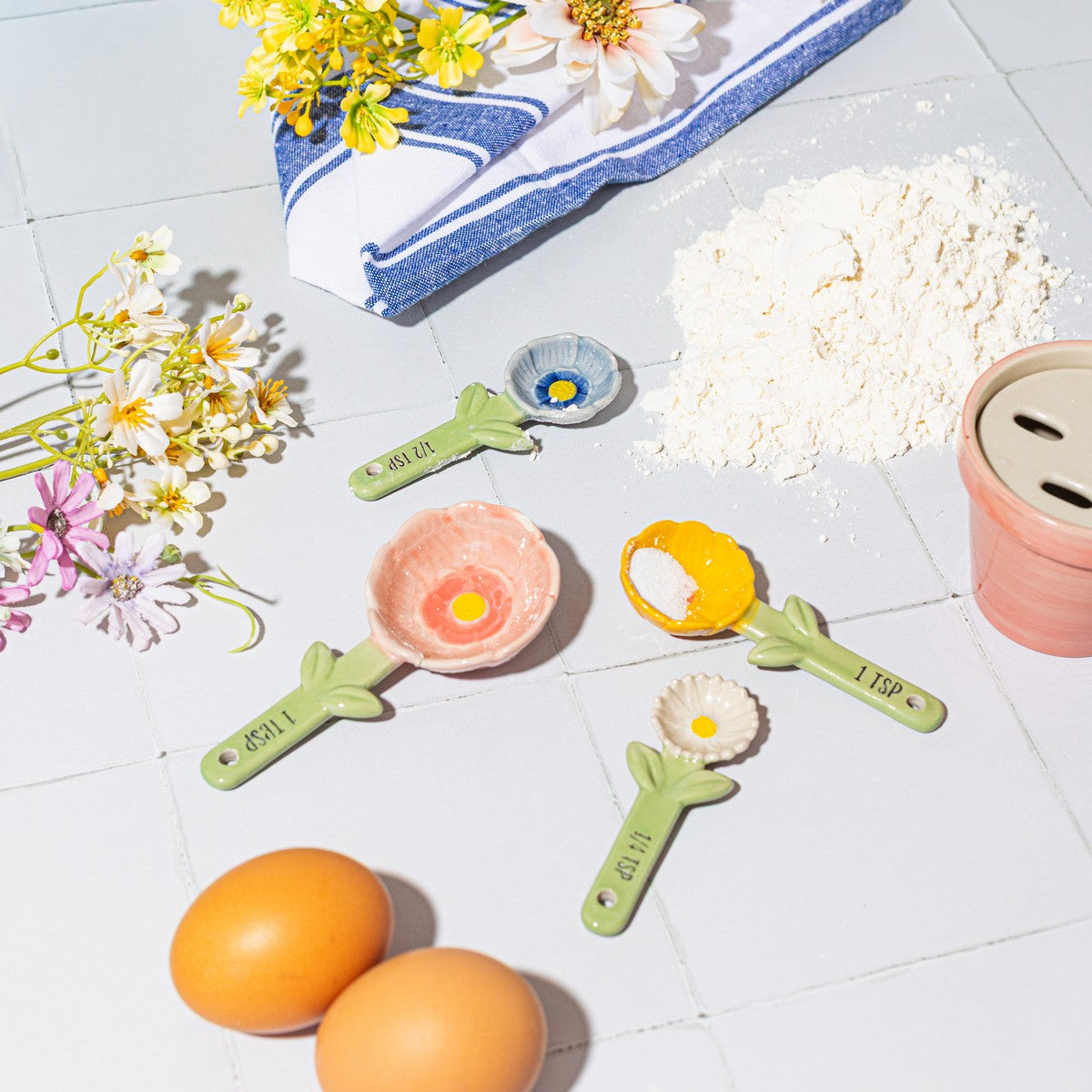Pink rose shaped ceramic measuring spoon being used for baking