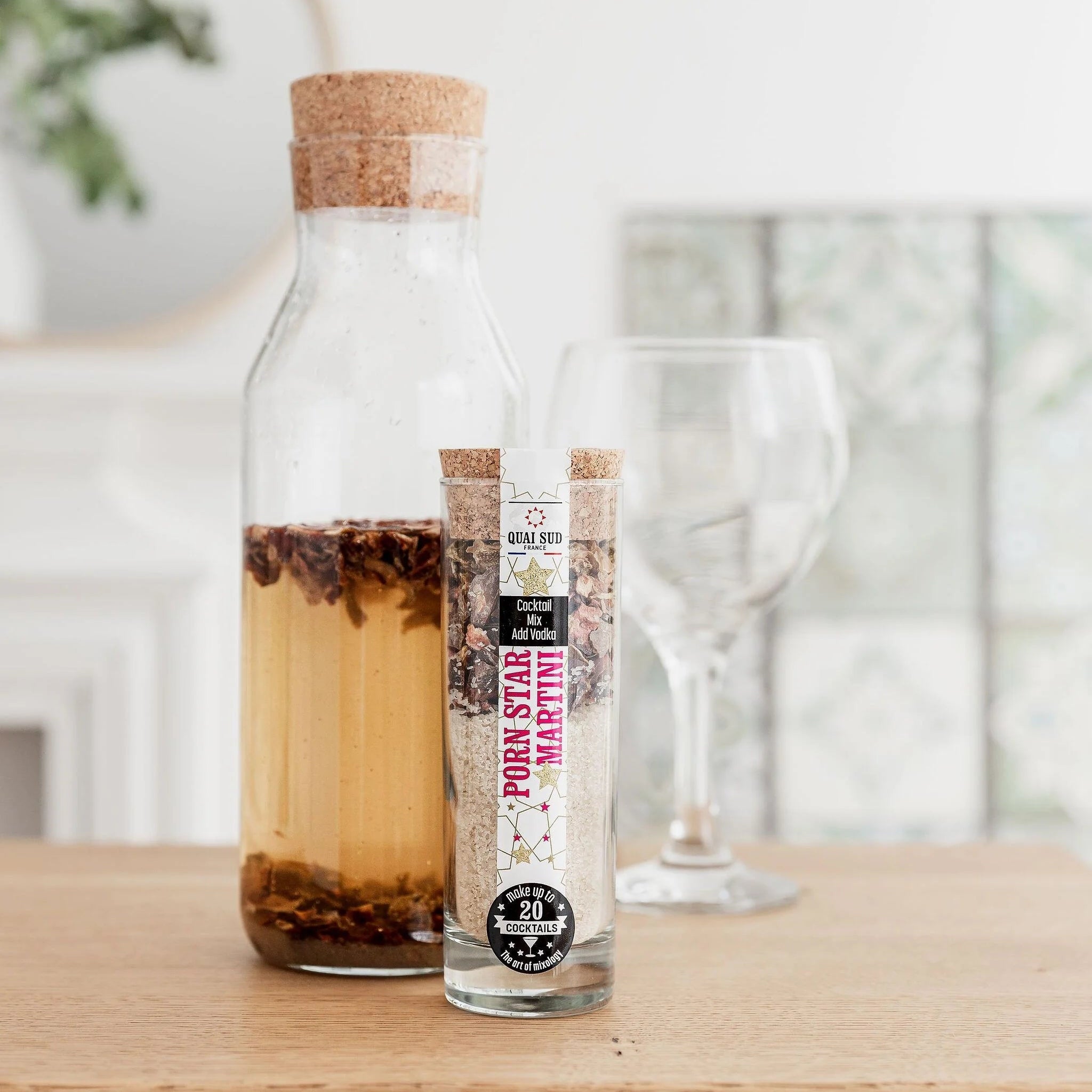 Infused Porn Star Martini Mix with glass and cork beside it.