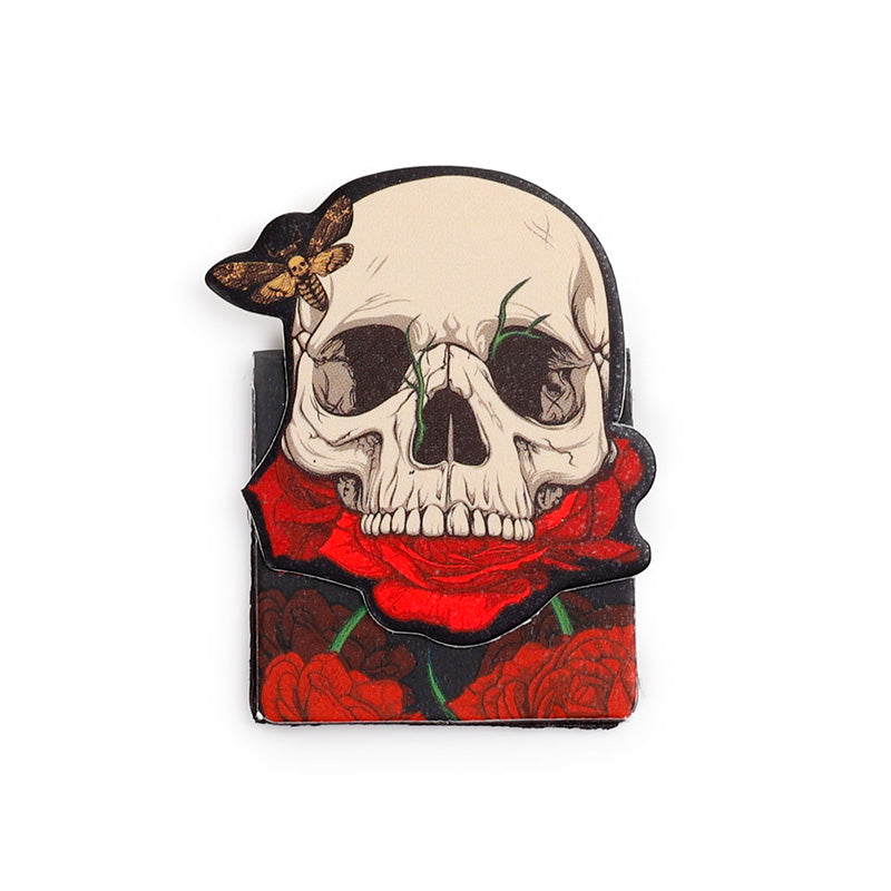 Front facing skull magnetic bookmark on a bed of red roses
