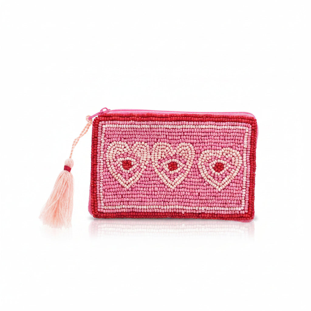 Beaded coin purse with three hearts in pink and red on white background