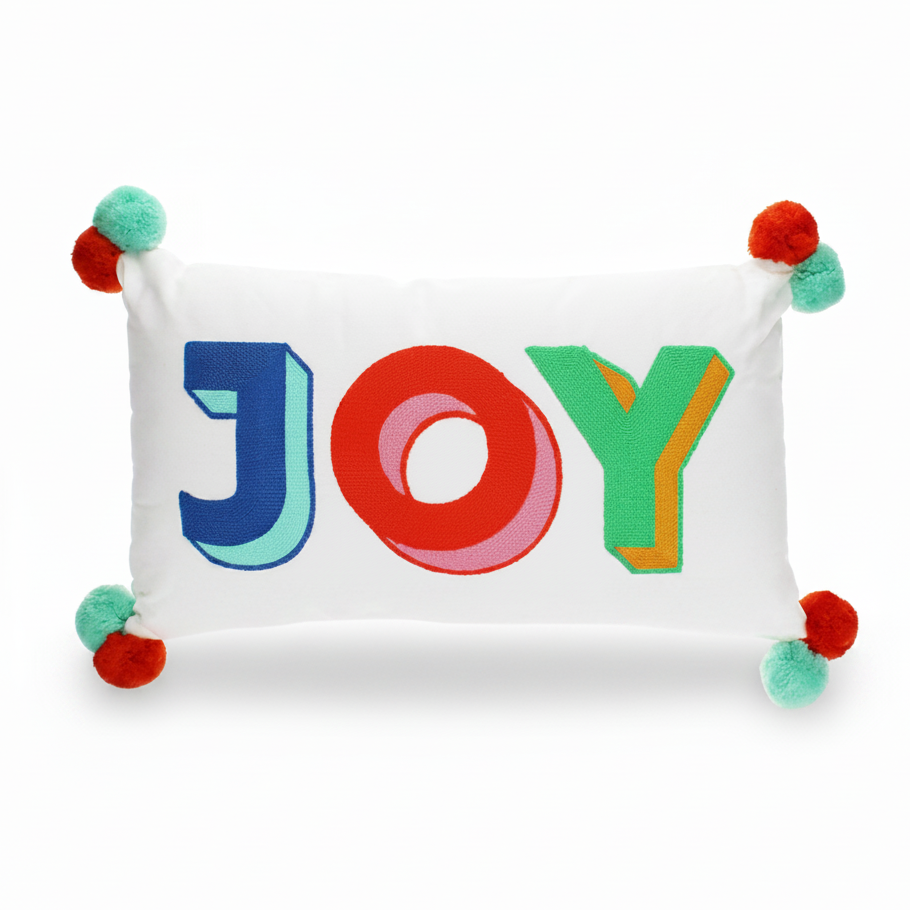 Joy embroidered pom pom cushion front view on grey background
