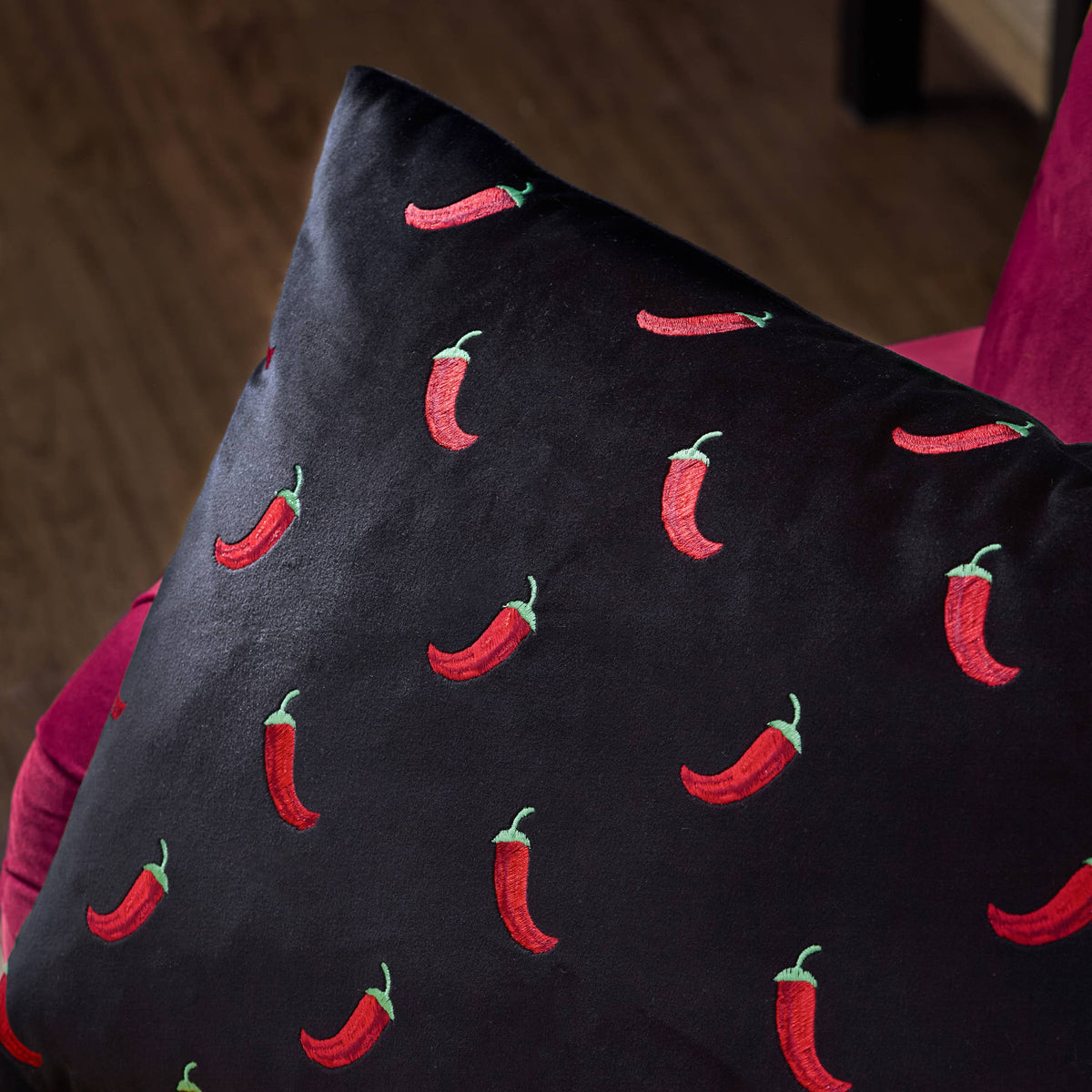 Chillies cushion angled view showing the velvet sheen