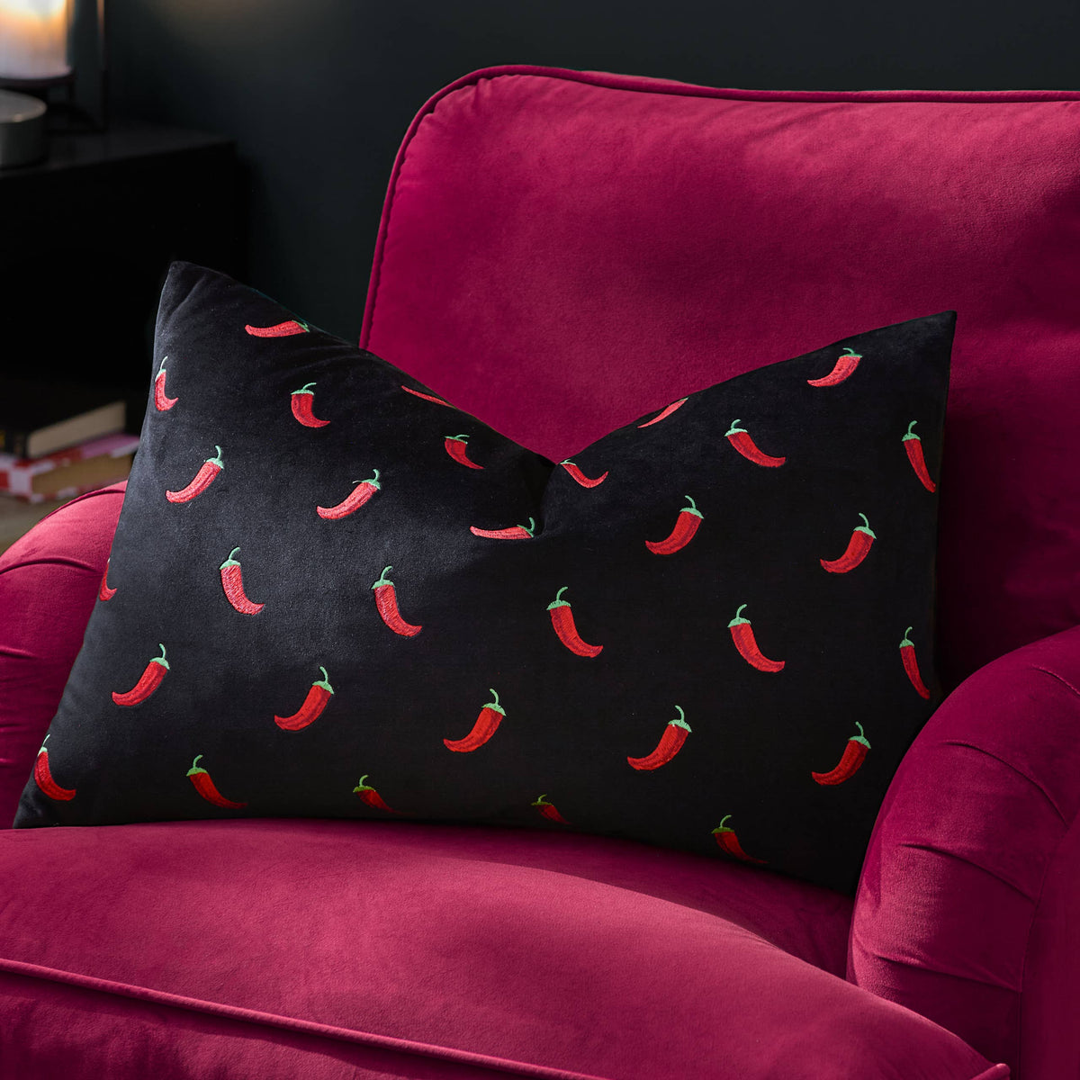 Chillies cushion on a pink velvet armchair