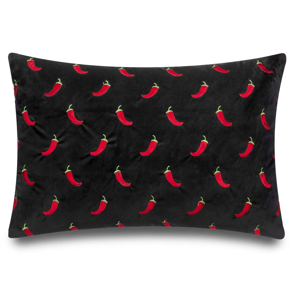 Chillies embroidered black velvet cushion front on a white background
