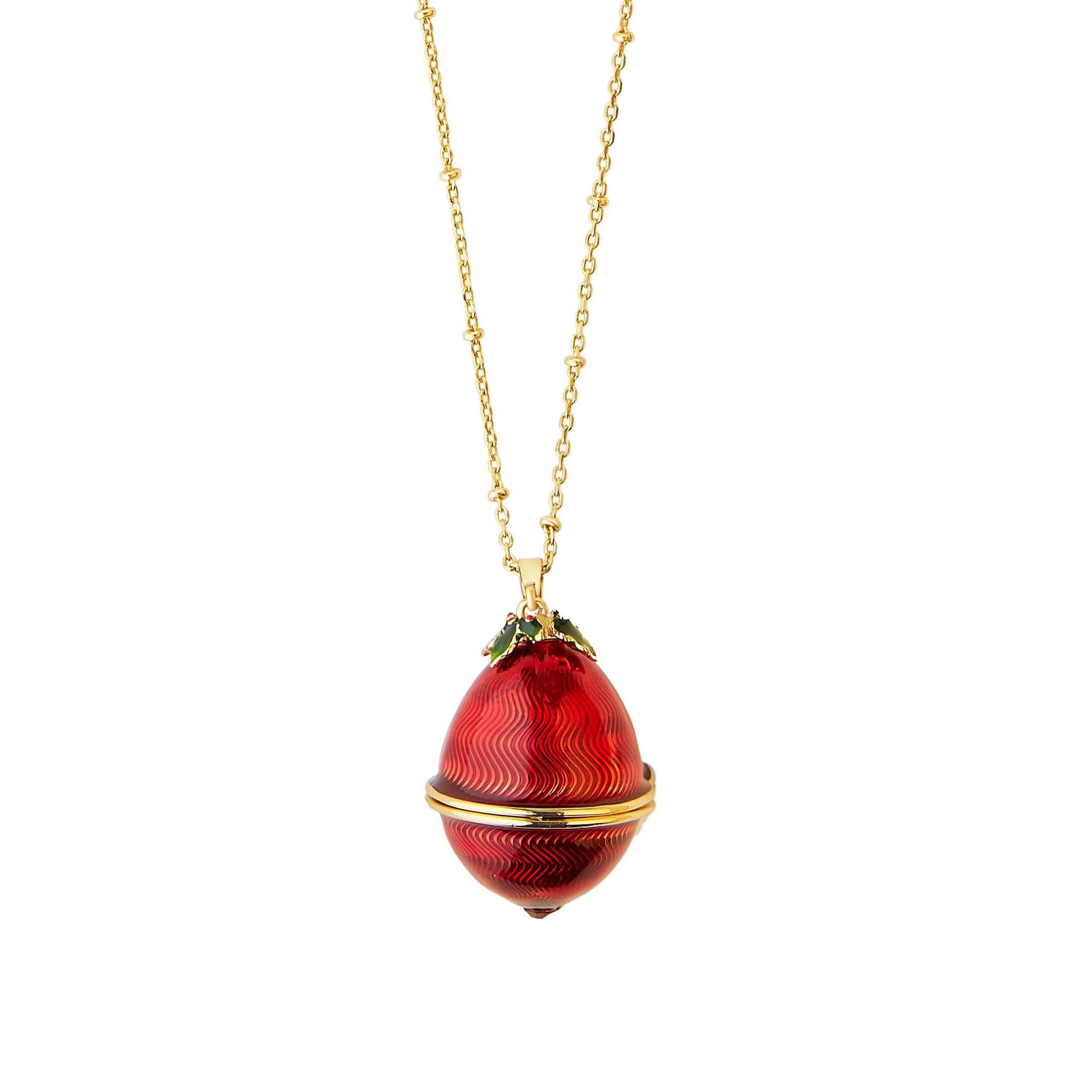Bill Skinner Robin Egg Locket closed, showing red enamel egg with gold holly leaf detailing on long gold chain.