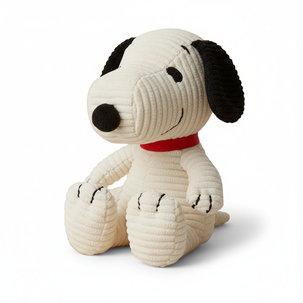 Snoopy corduroy cream soft toy with red collar on knitted blanket