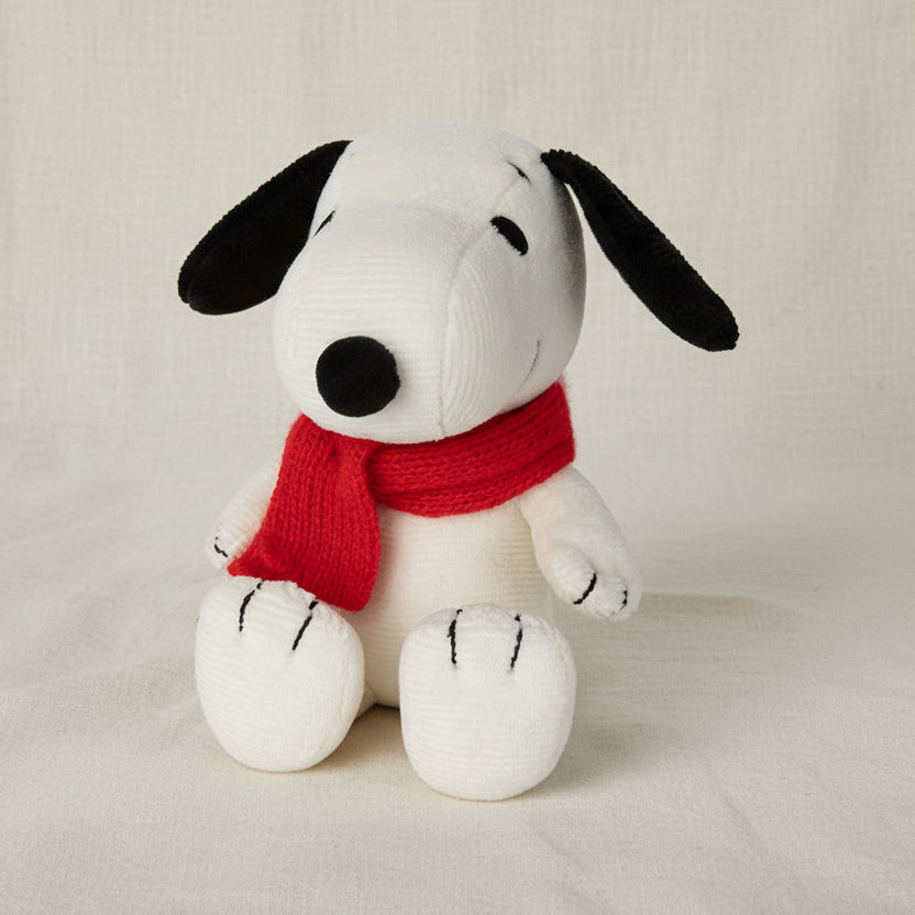 Snoopy corduroy soft toy with red scarf on cream fabric background