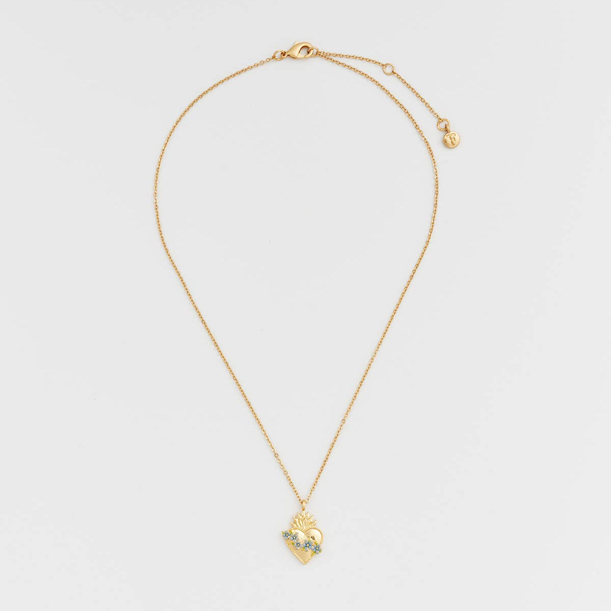 Gold and blue sacred heart necklace full length on white background.