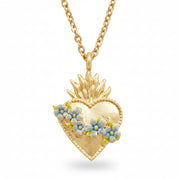 Gold sacred heart necklace with blue floral pendant on white background.