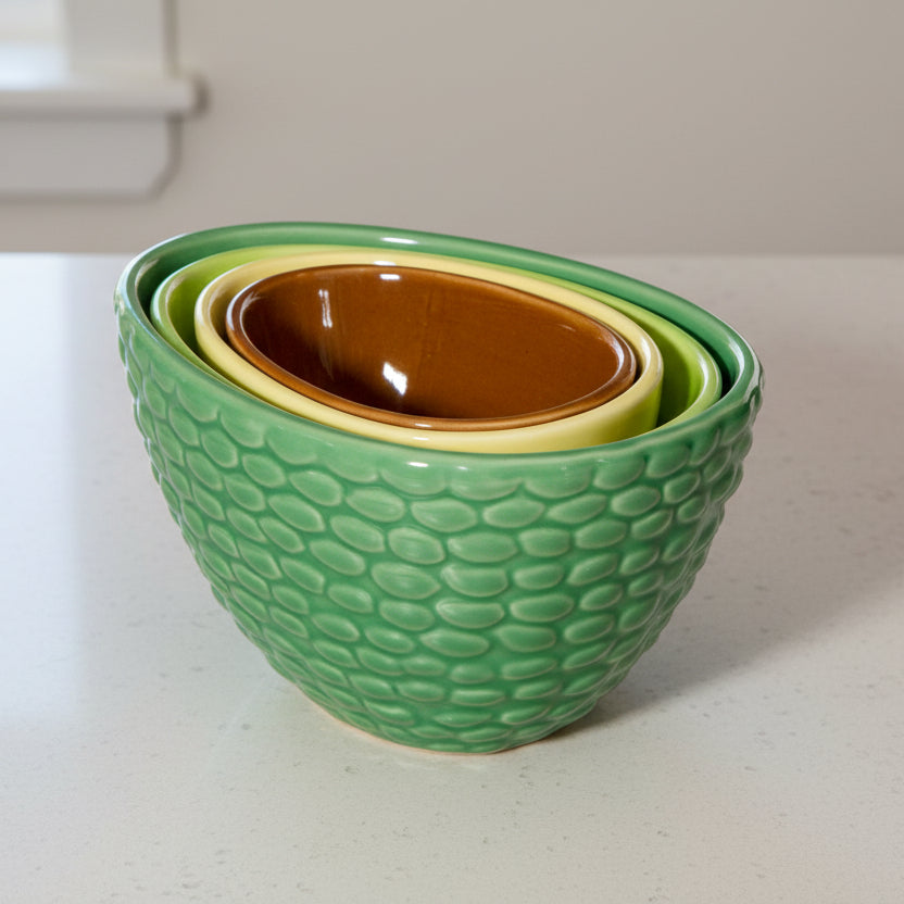 Avocado measuring cups stacked together on kitchen countertop showing nesting design