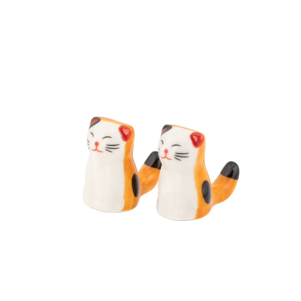Cat chopstick rests at an angle showing ginger tabby markings, on white