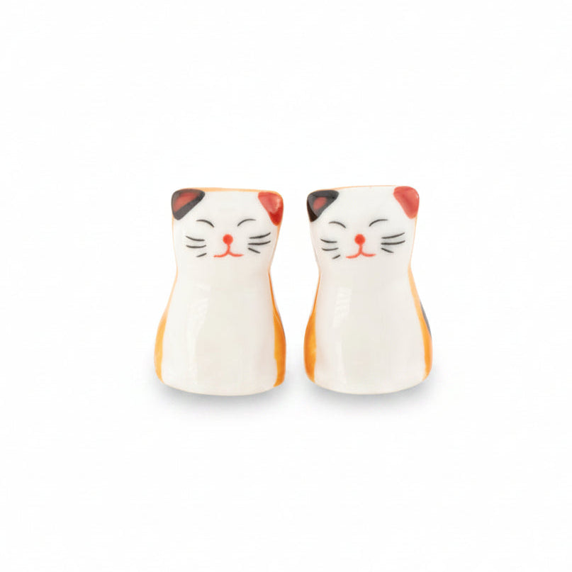 Cat chopstick rests, pair of white and ginger porcelain cats, on white background