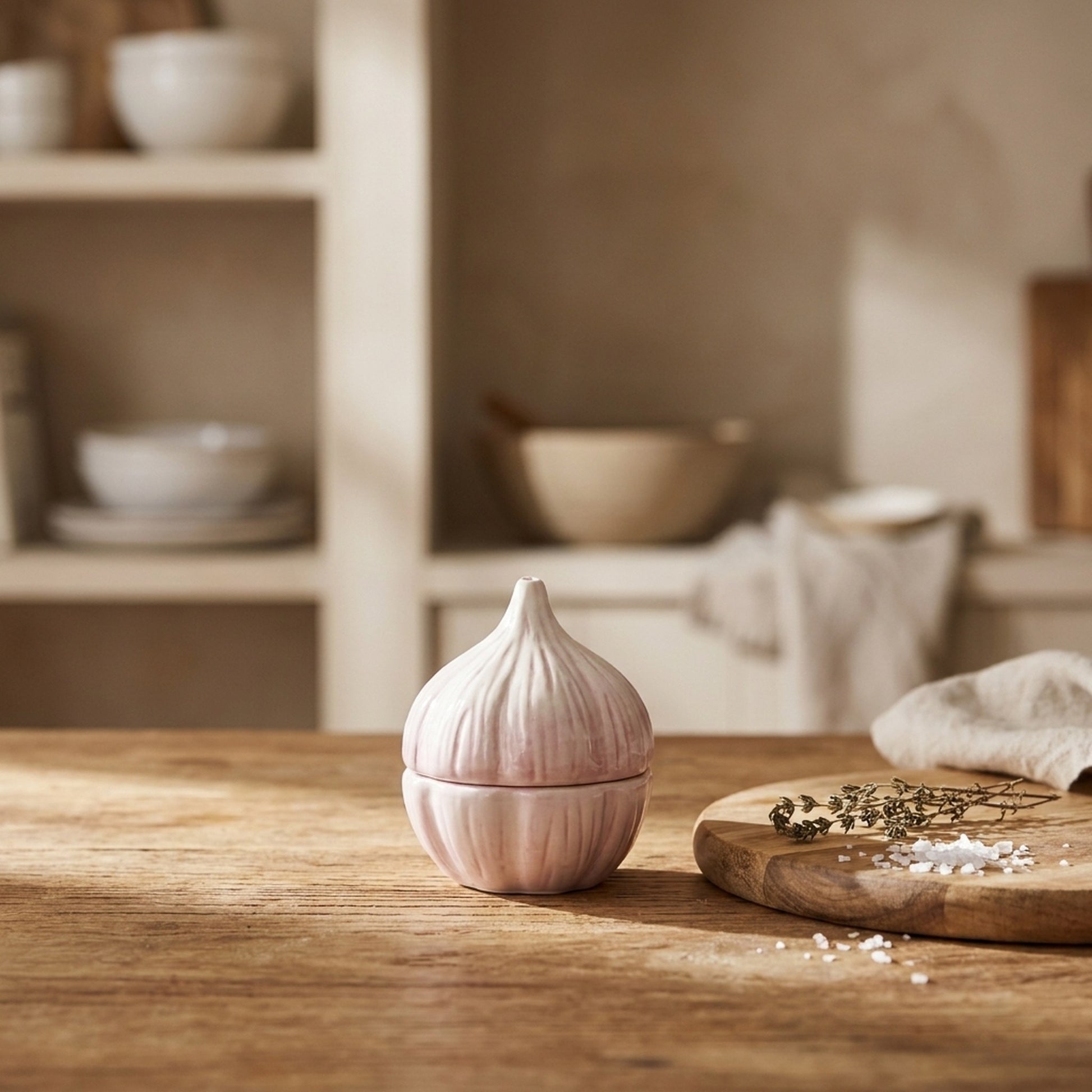 Garlic Salt and Pepper Shakers stacked on a wooden kitchen counter