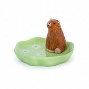 Highland cow ceramic trinket dish with green daisy design on white background