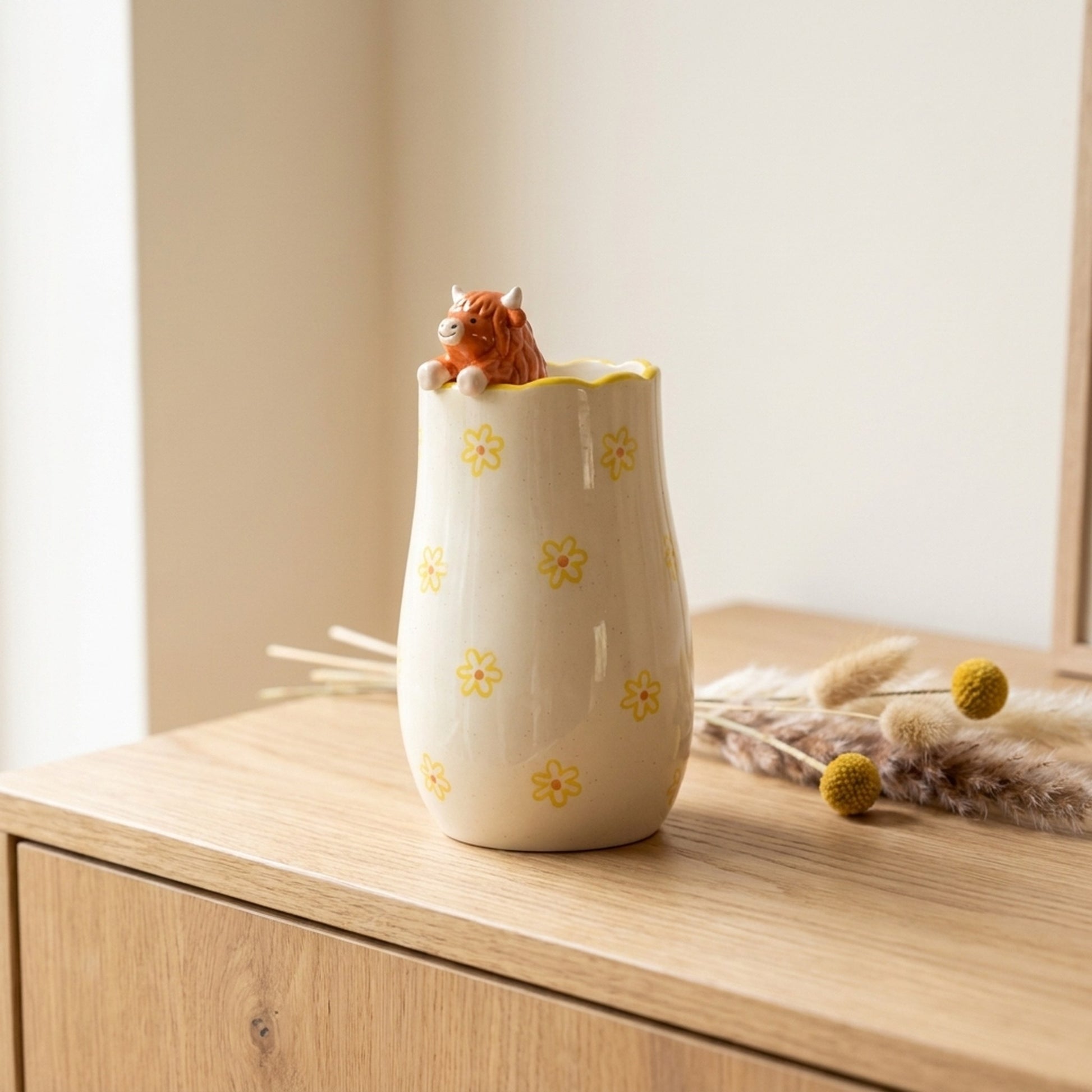Peeking Highland Cow Vase on a light wood sideboard with dried flowers