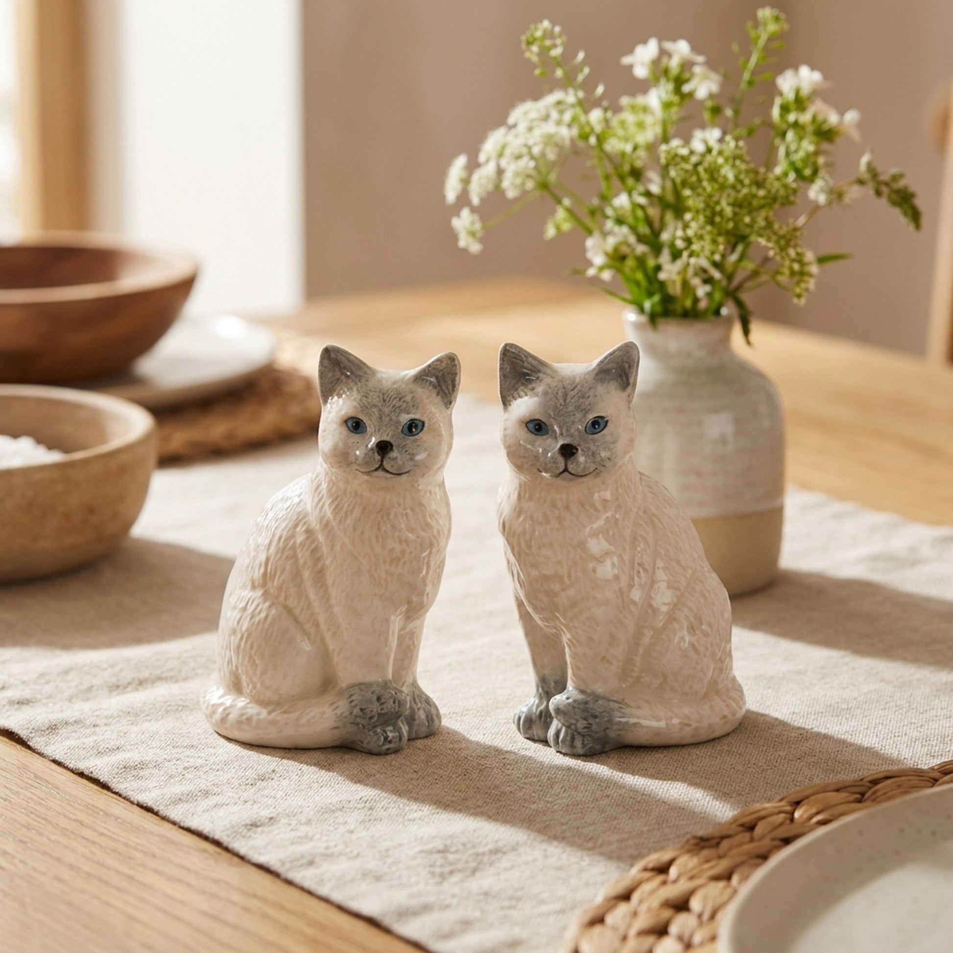 Ragdoll Cat Salt and Pepper Shakers on a dining table with flowers