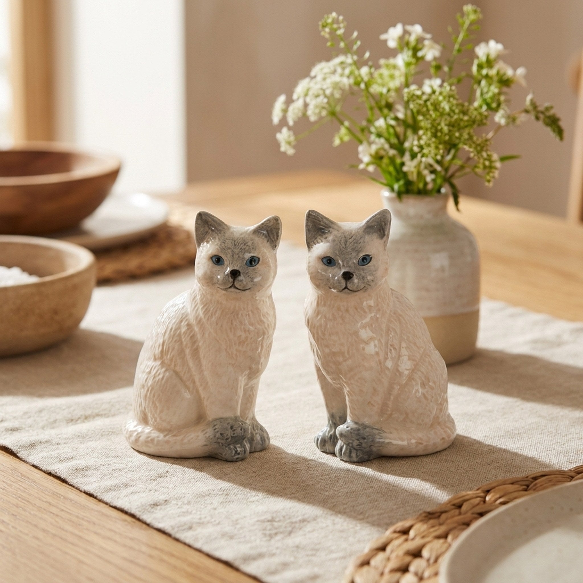 Ragdoll Cat Salt and Pepper Shakers on a dining table with flowers