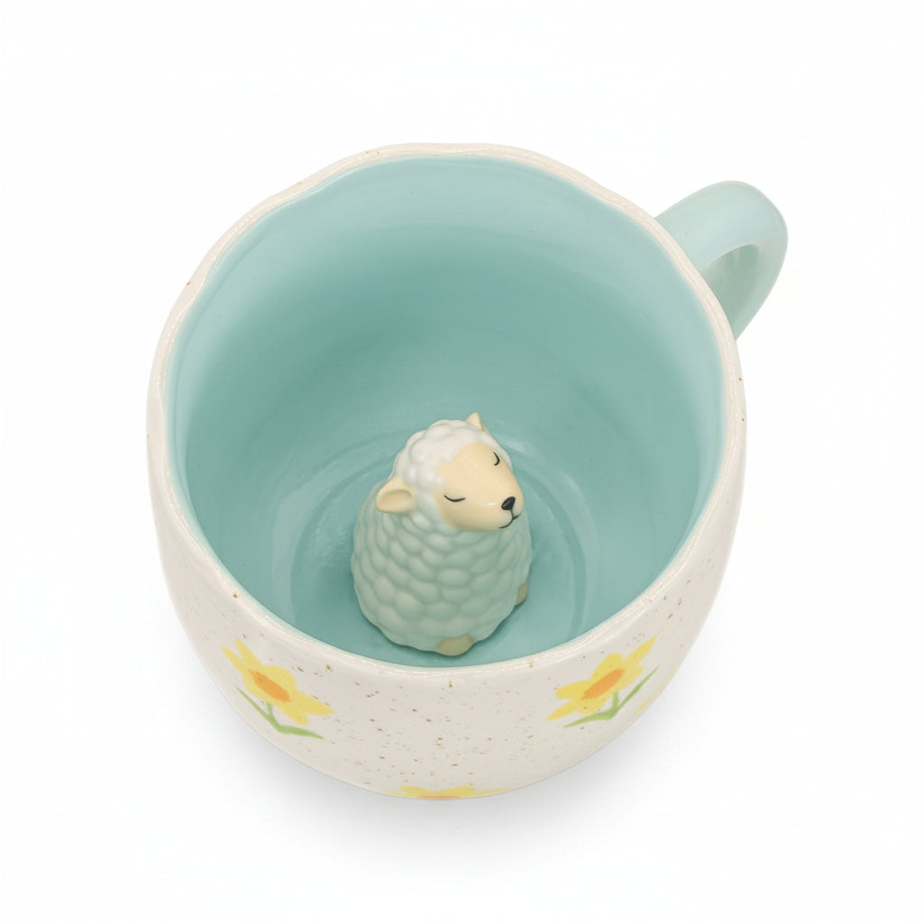 Surprise sheep mug interior showing a little sheep figure inside, on white